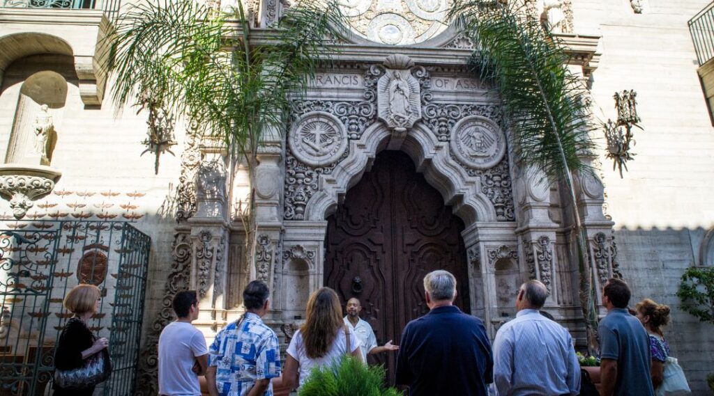 Photograph of a tour group in front of the St. Francis Chapel doors.